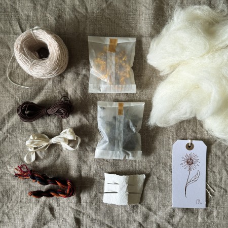 Felt bead making kit with vintage wool yarn, natural dye flowers and silk cord in glassine packaging